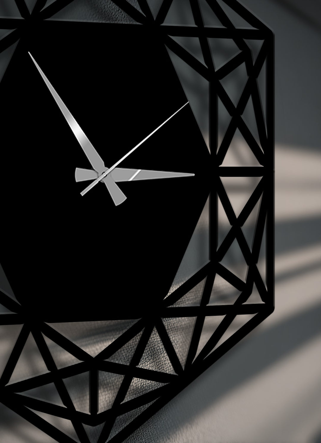 The striking silver clock hands boldly cross the dark hexagonal face of this modern minimalist geometric metal art for wall.