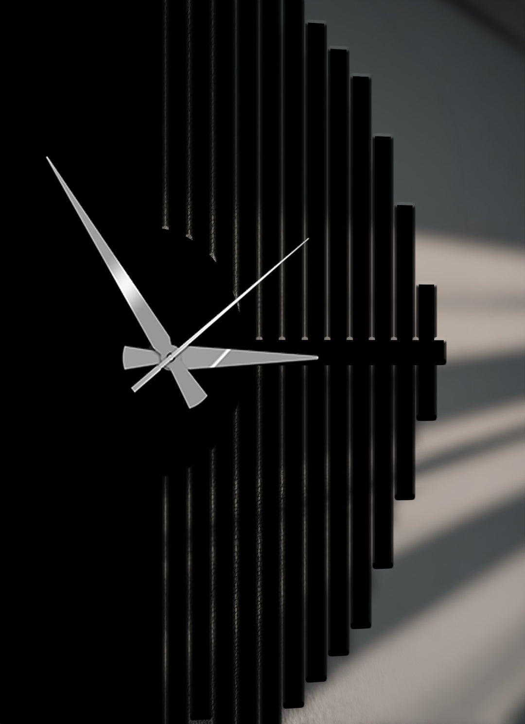 Sleek silver hands dramatically contrast against the dark face of this unique metal wall art, a modern geometric half-circle wall clock.