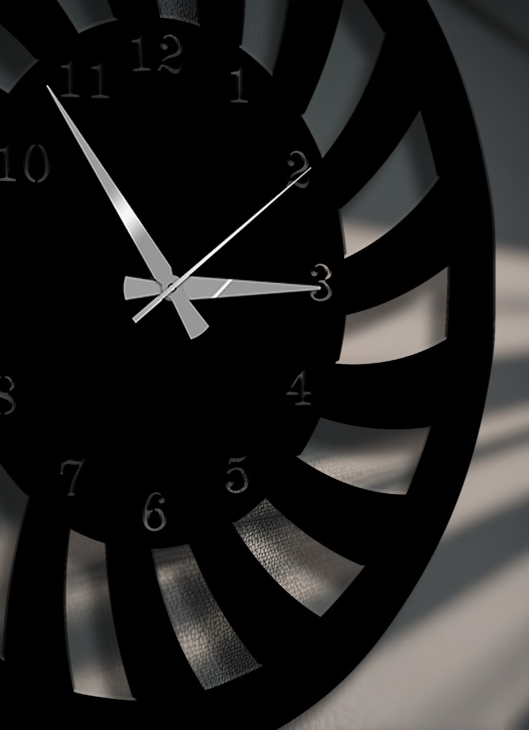 The brightest areas highlight the reflective clock hands and the subtle textures seen through the dynamic spiral cutouts of this unique metal wall art.