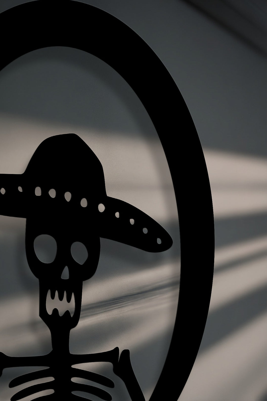 The realistic detail of this Sombrero Skeleton metal wall art reveals crisp cuts and dramatic shadows as unique decoration wall art.