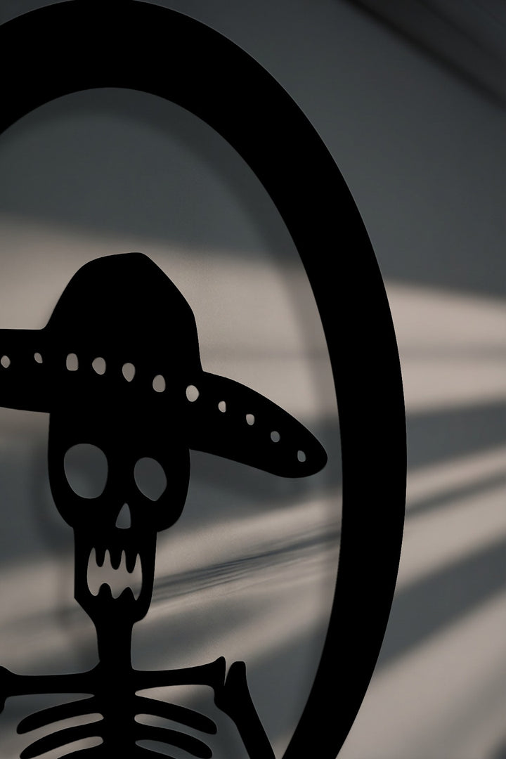 The realistic detail of this Sombrero Skeleton metal wall art reveals crisp cuts and dramatic shadows as unique decoration wall art.