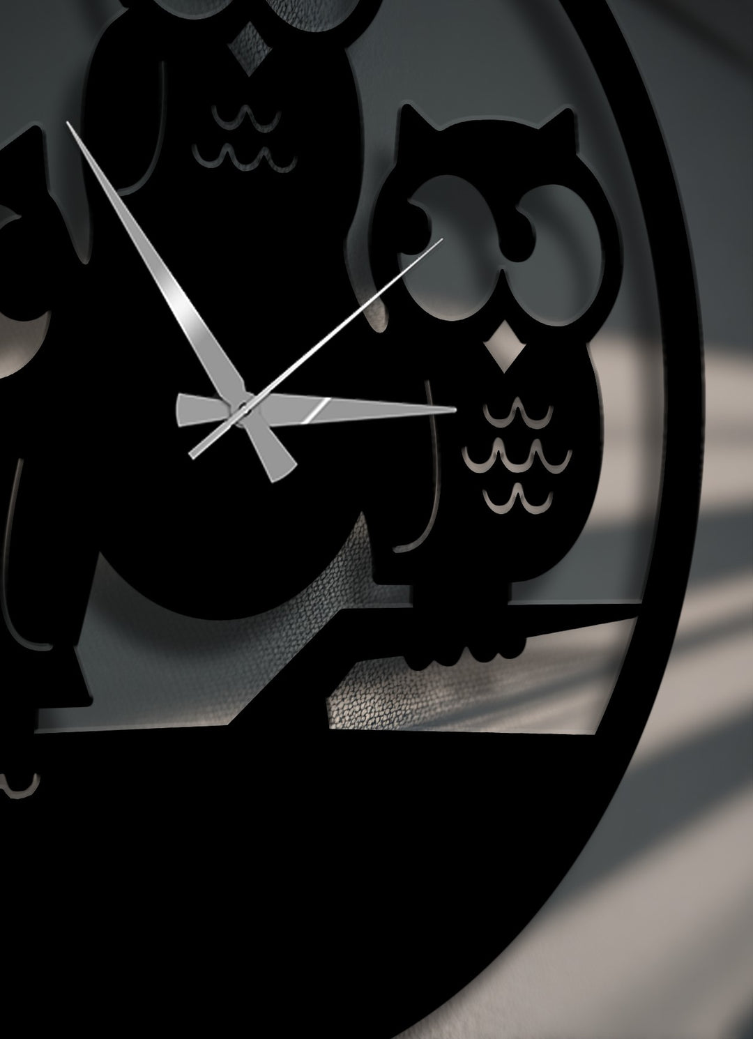 A gentle, warm color temperature softly illuminates the elegant three owls silhouette decorative metal art wall clock.