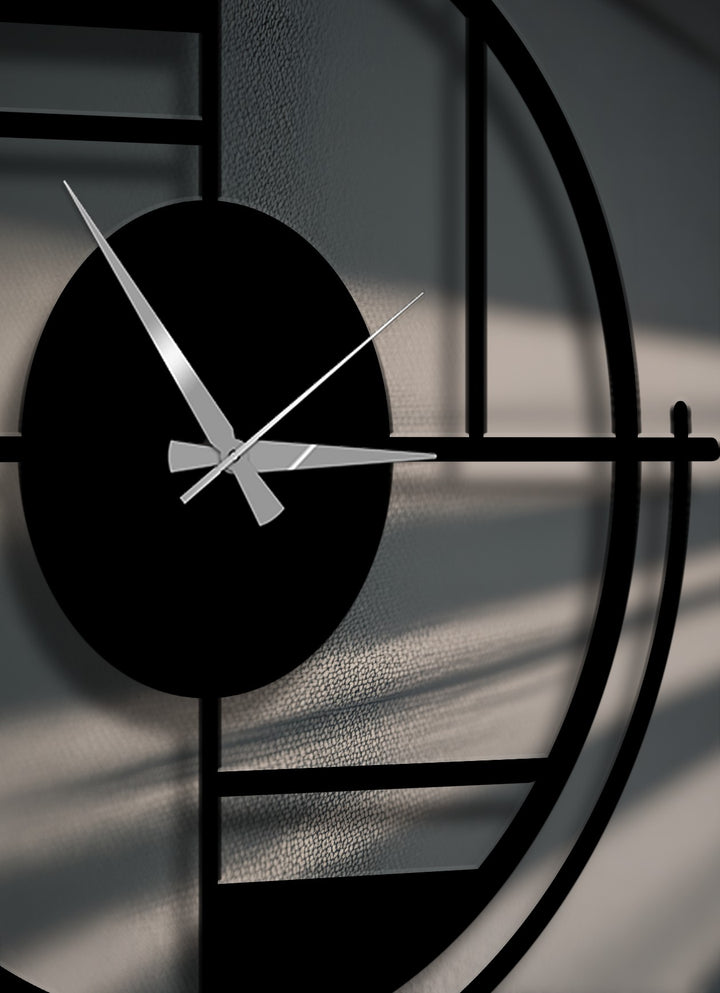 The striking color contrast between the bold black geometric circle metal artwork clock and its silver hands creates a dynamic visual.