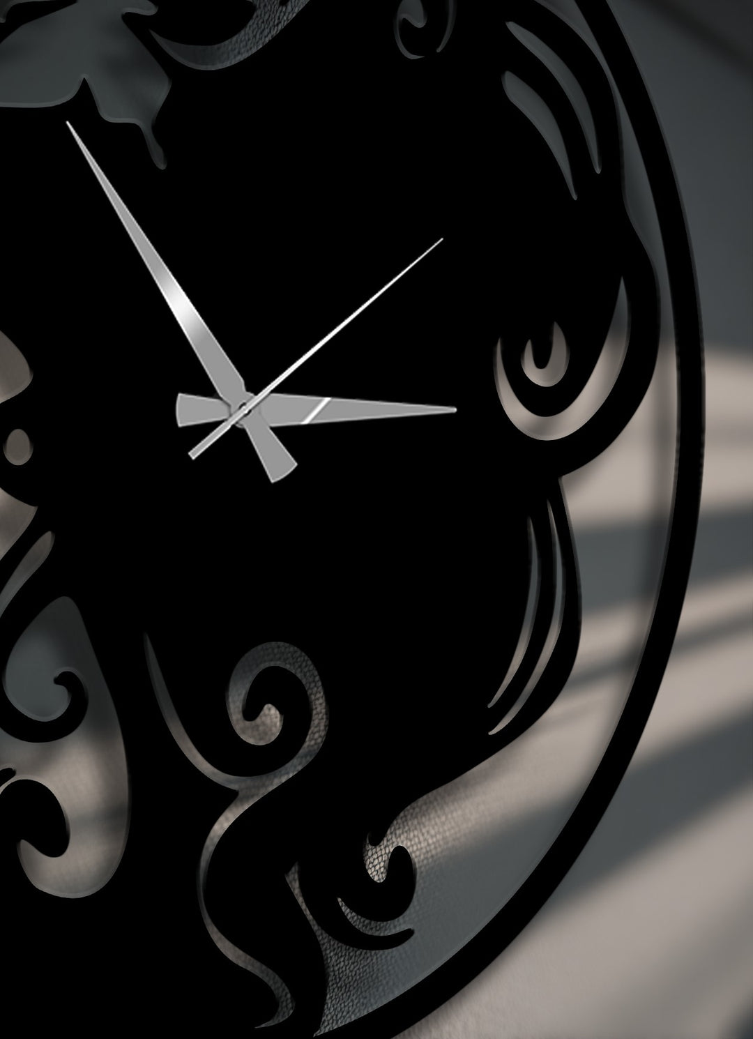 Geometric elements, including elegant scrollwork and butterfly-inspired cut-outs, define this sophisticated black metal artwork wall clock.