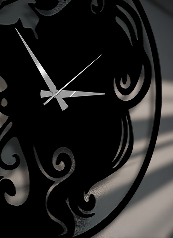 Geometric elements, including elegant scrollwork and butterfly-inspired cut-outs, define this sophisticated black metal artwork wall clock.