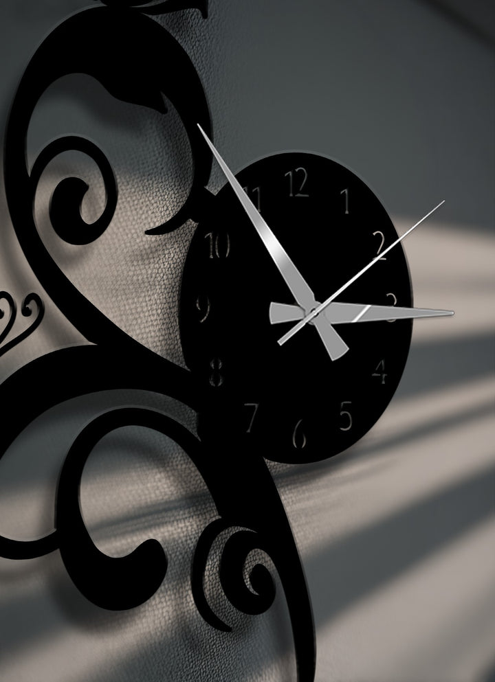 The compelling negative space between the elegant flowing vine metal artwork of the wall clock highlights the textured surface.