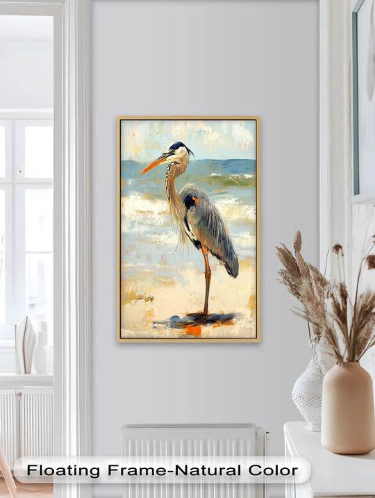 Framed oil painting art piece of a great blue heron standing tall on a sandy beach with crashing waves, a captivating and textured showcase of nature's elegance.