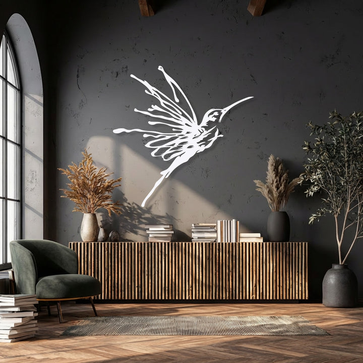 The realistic detail of this elegant flying hummingbird metal artwork is captured by its artistic, flowing lines on a dark textured wall.