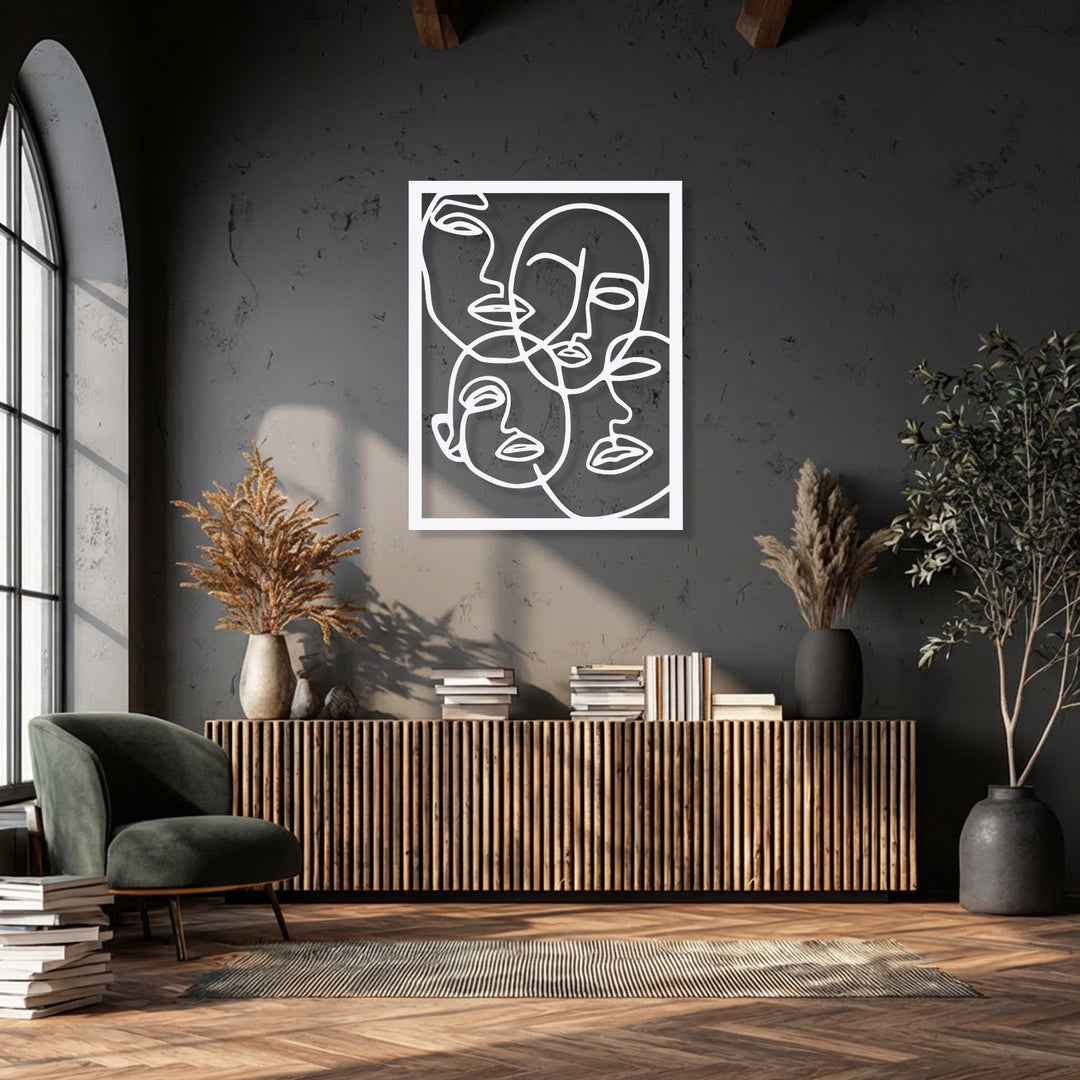 The deep charcoal wall highlights the minimalist abstract faces line art, a stunning metal decoration wall art piece, above a fluted wooden console.