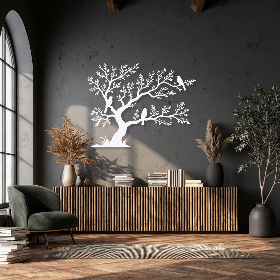 The crisp, well-defined edges of the white birds on tree metal art for wall create a clean silhouette against the dark, textured wall.