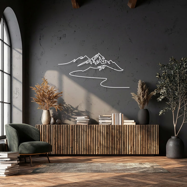 The visual rhythm of the flowing lines in the minimalist mountain metal art for wall creates a calm, modern landscape above a ribbed console.