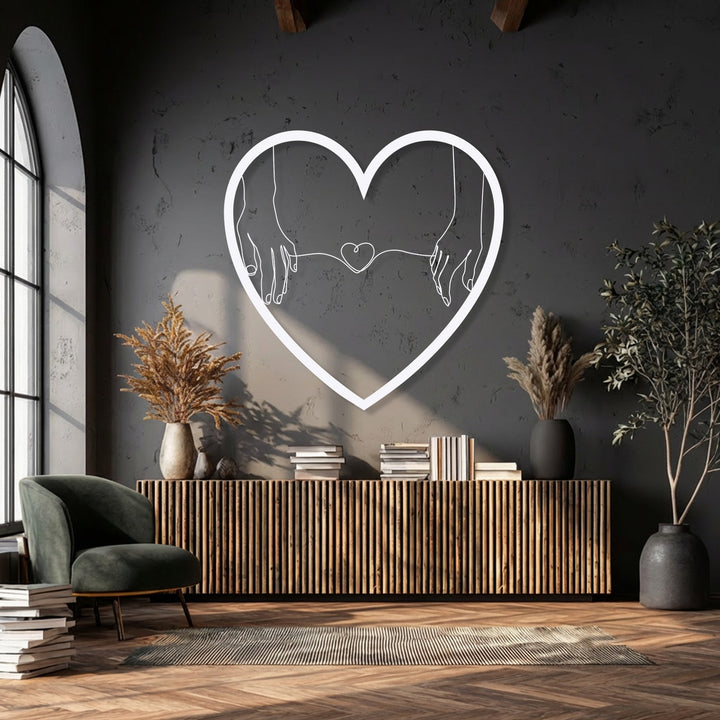 The soft, warm light enhances the minimalist heart hands metal wall art, creating a cozy ambiance for this romantic decoration wall art.
