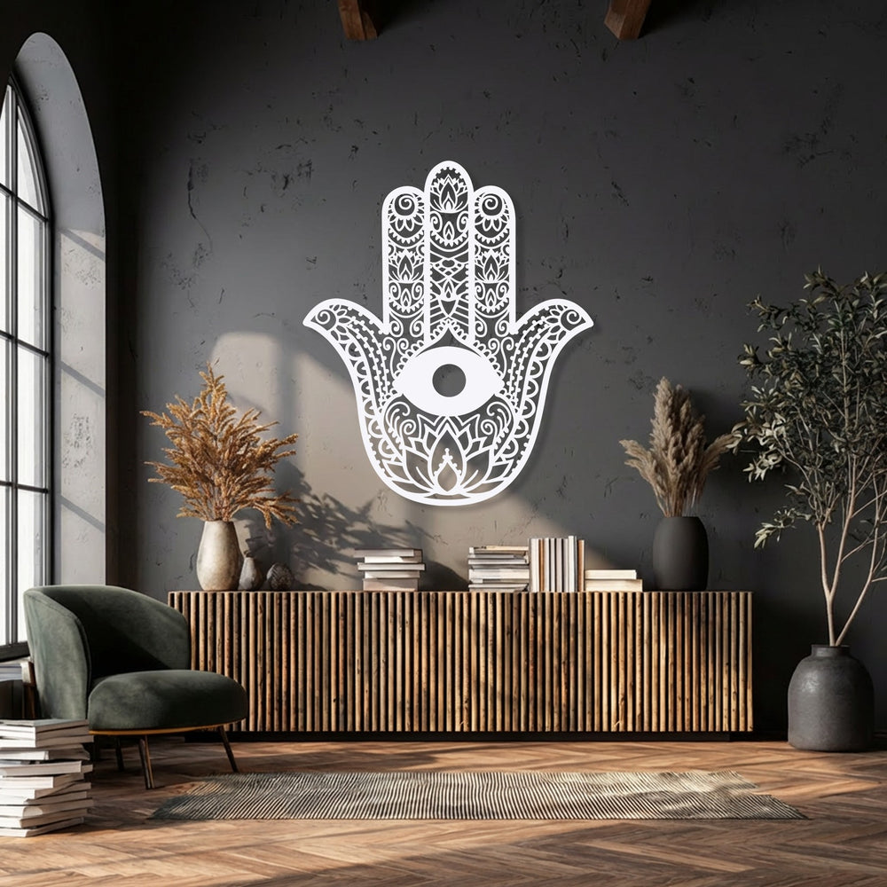 The negative space of this white Hamsa Hand metal decoration wall art vividly contrasts with the dark wall, emphasizing its delicate evil eye design.