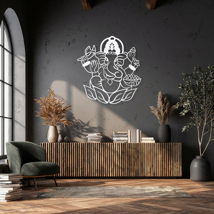 The background features a dark, textured wall softly illuminated by light, providing a striking contrast to the Ganesha unique metal wall art.