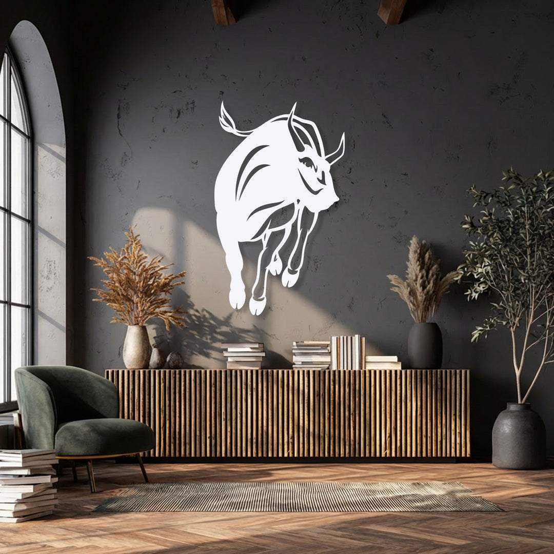 Cool and warm tones balance a decorative metal art charging bull silhouette against a dark wall with natural light.