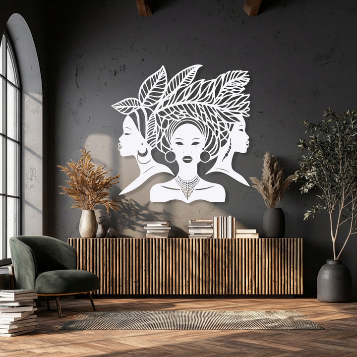 The strong color contrast of the vivid white African Queen Silhouette metal art for wall dramatically stands out against the dark wall.