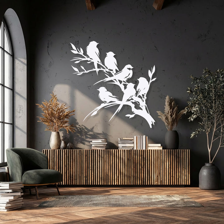 Dramatic light and shadow play across the intricate birds on branch metal art for wall, highlighting its elegant silhouette against the textured dark gray wall.