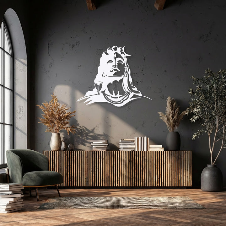 The smooth white finish of this spiritual Lord Shiva metal wall decor beautifully highlights its striking silhouette against the dark wall.