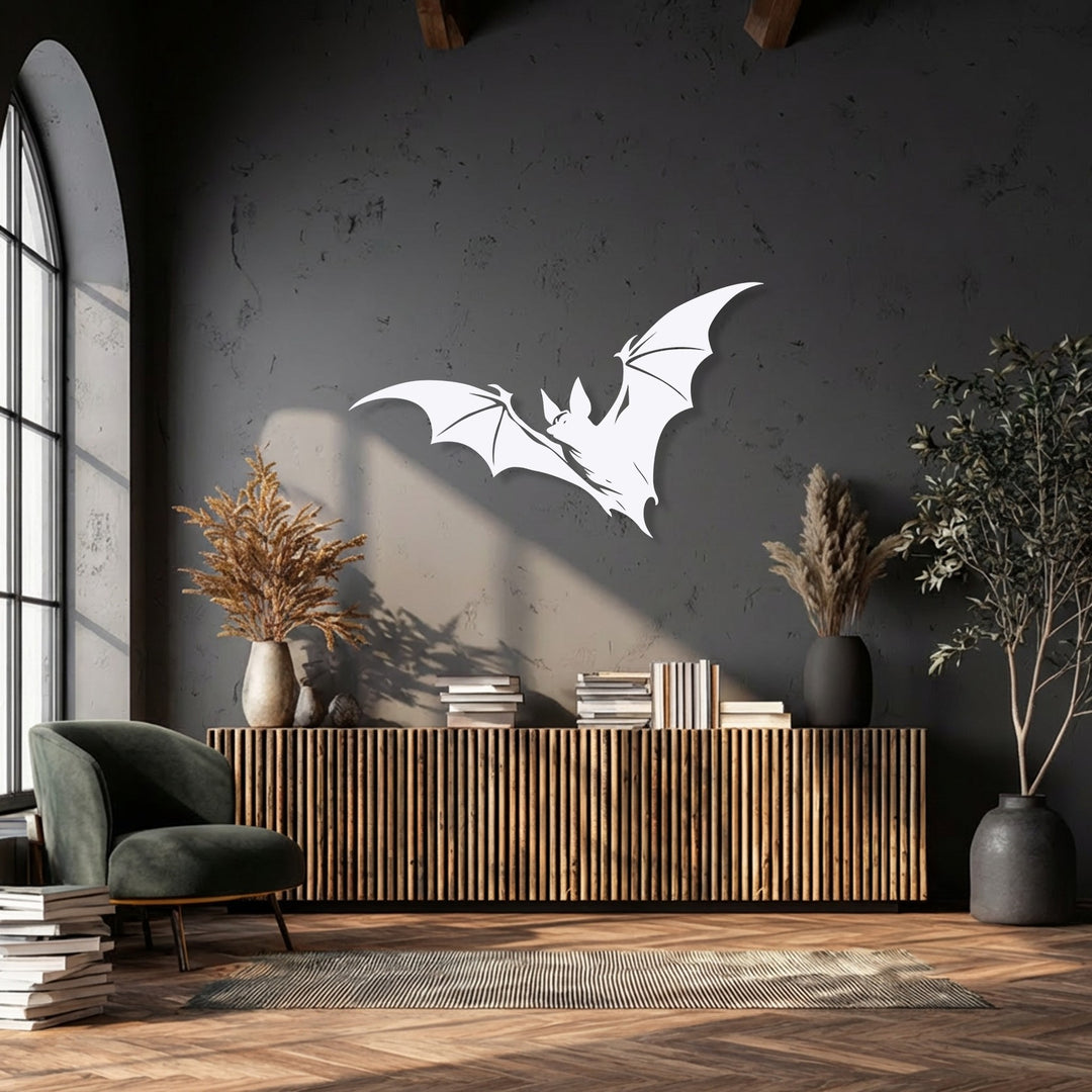 The layering effect is clear: white flying bat metal wall decor casts shadows, adding depth to the dark, textured wall surface.