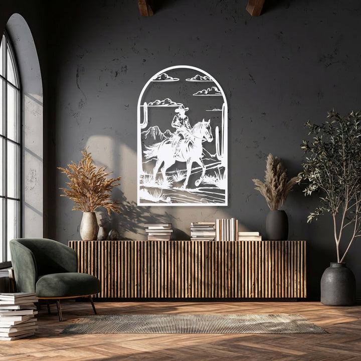 The stillness of a Western desert scene, featuring a cowboy on horseback, beautifully rendered as intricate metal artwork.