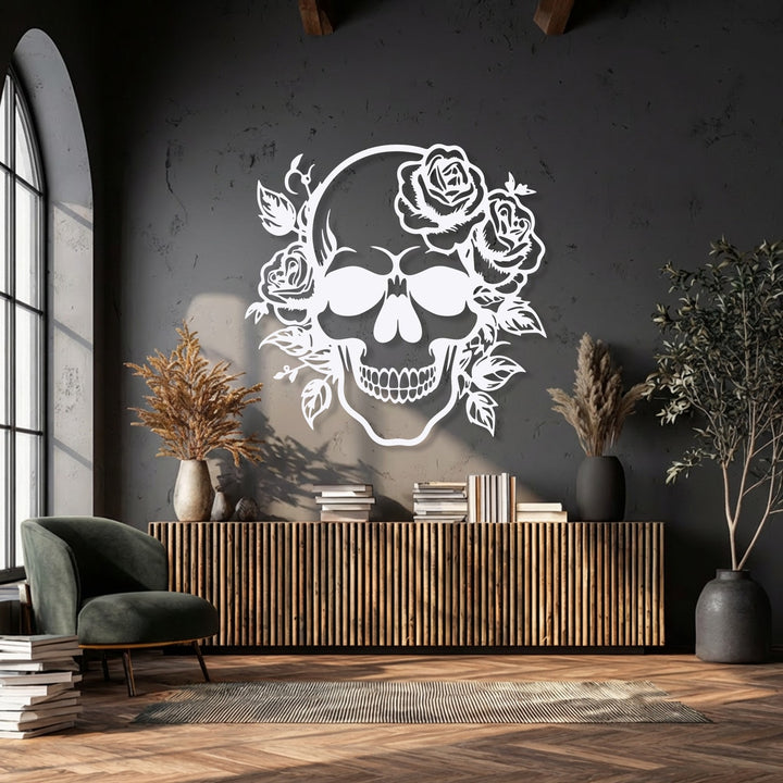 The negative space of the dark wall powerfully outlines the intricate white floral skull decorative metal art.