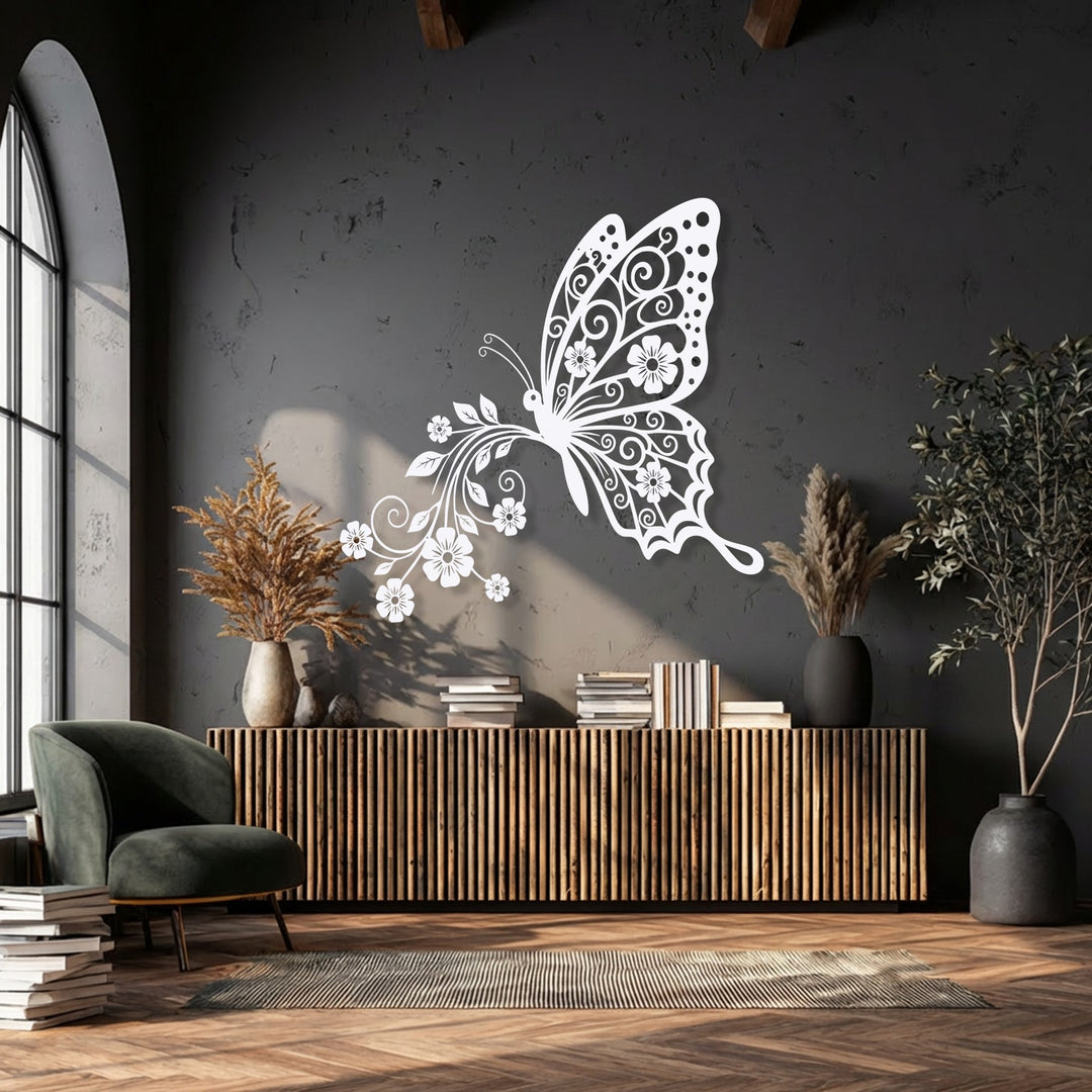 The brightest area highlights the ornate white butterfly with delicate floral wings, a unique metal wall art piece adorning a dark charcoal wall.