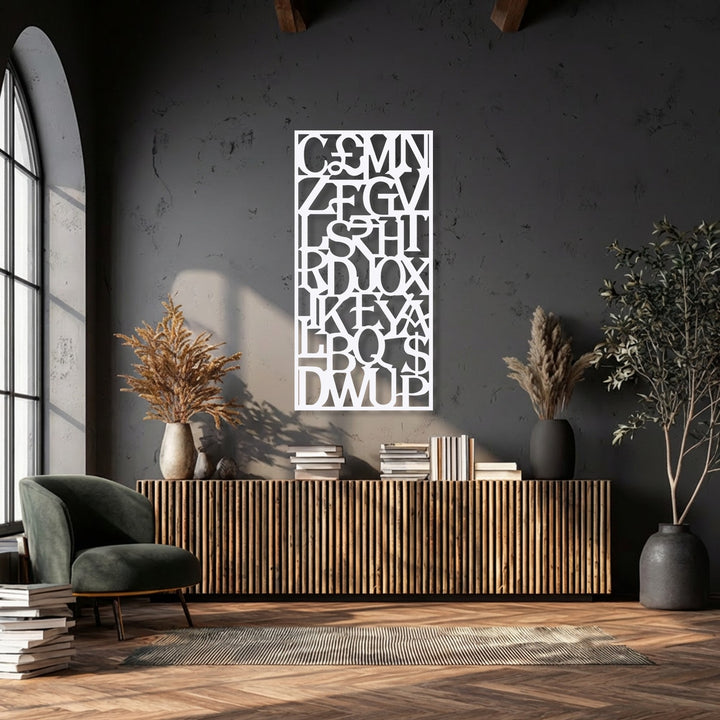 Realistic detail is apparent in the sharply cut abstract alphabet metal art for wall contrasting the dark textured wall.
