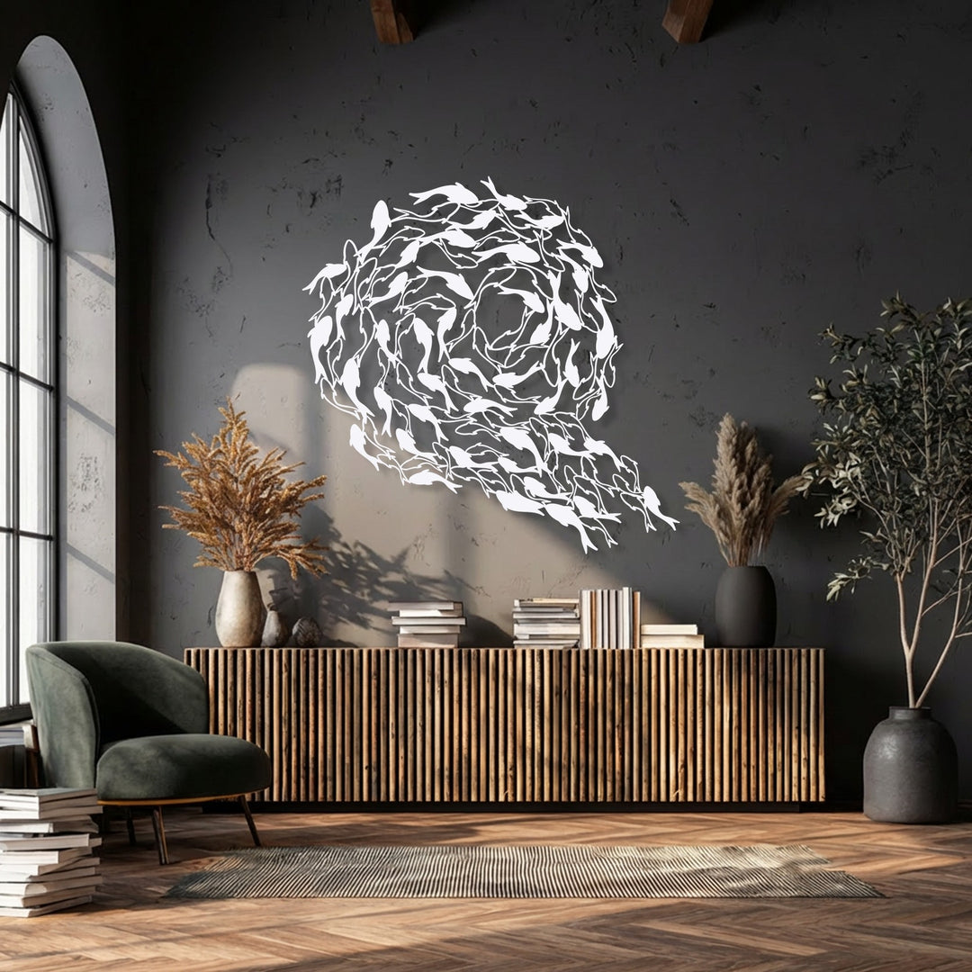 The dark gray, textured wall, perfect for displaying metal artwork, is illuminated by an arched window and topped with a rustic beam.
