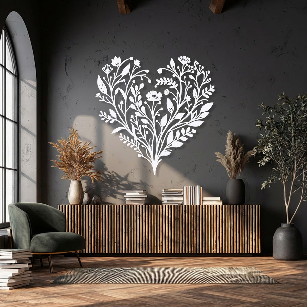The matte white finish of the botanical heart metal decoration wall art creates a striking contrast against the dark textured wall.
