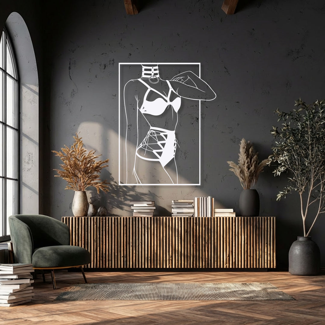 The stillness of the room is accentuated by a striking minimalist female silhouette line art metal artwork on a dark wall.