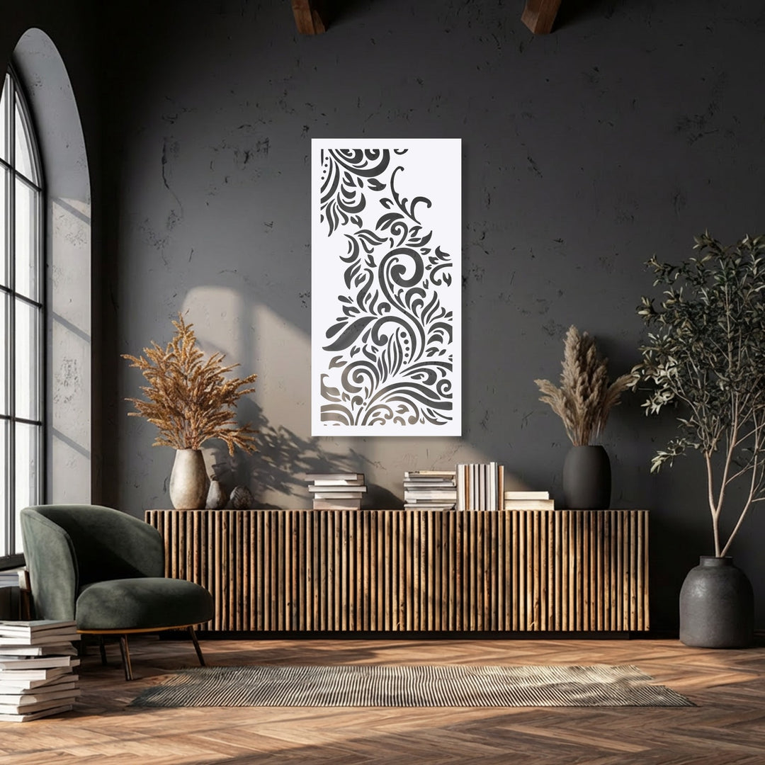 The warm color temperature of the sunlight highlights the ornamental floral swirl panel, a unique metal wall art piece, against the cool dark walls.