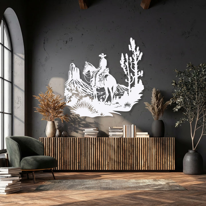 The dark wall's negative space highlights the intricate white Western Cowboy Landscape – Desert Horse Rider metal artwork, defining its rugged desert scene.