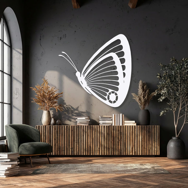 Surface textures abound, from the rough wall and smooth white decorative metal art butterfly to the ridged wooden cabinet and soft velvet chair.
