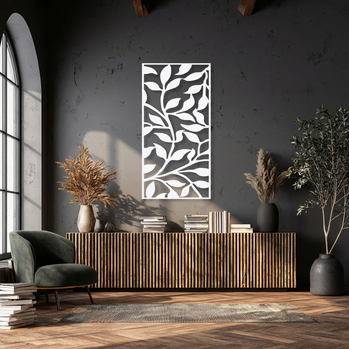 A vertical rectangular decorative metal art piece displays an intricate abstract leaf branch pattern, providing modern botanical elegance.