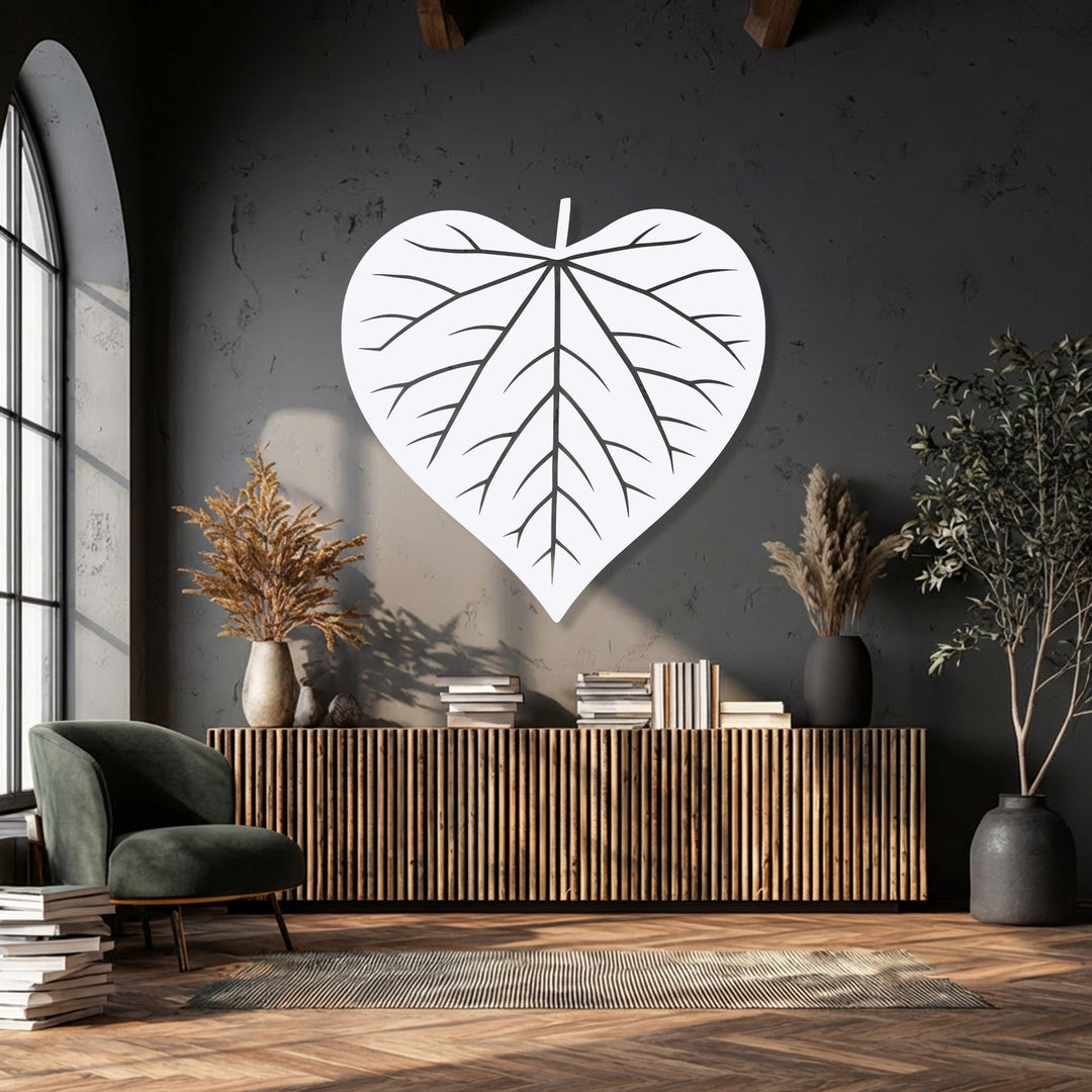 Featuring prominent depth and layers, a heart-shaped leaf decorative metal art piece stands out against a dark textured wall, complemented by layered room elements.