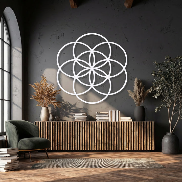 Mottled dark wall texture provides a backdrop for the smooth Sacred Balance Flower of Life metal wall decor, complemented by a ribbed wooden console.