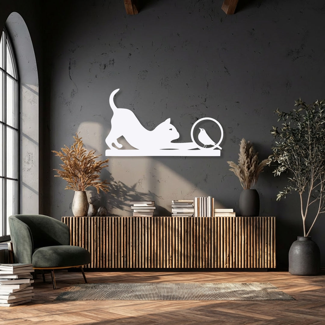 The stark white playful cat and curious bird silhouette metal artwork sharply transitions against the deep charcoal wall, enhancing its minimalist design.