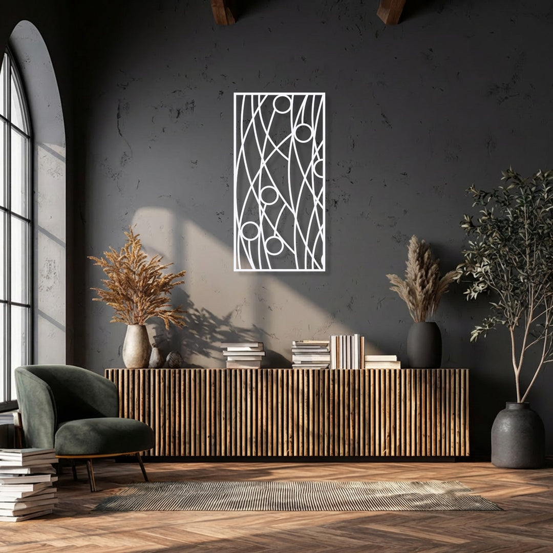 Strong sunlight creates dynamic shadows, emphasizing the abstract linear geometry of the decorative metal art against the deep, textured wall.