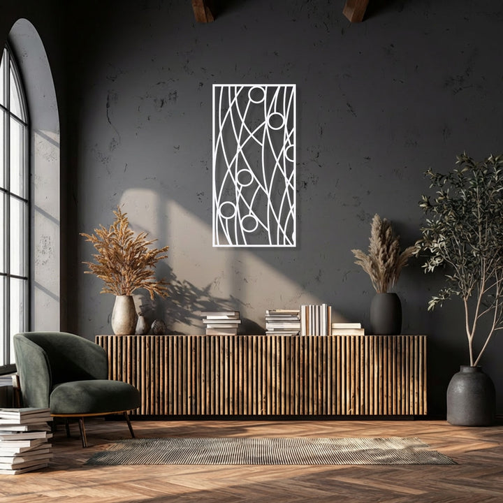 Strong sunlight creates dynamic shadows, emphasizing the abstract linear geometry of the decorative metal art against the deep, textured wall.