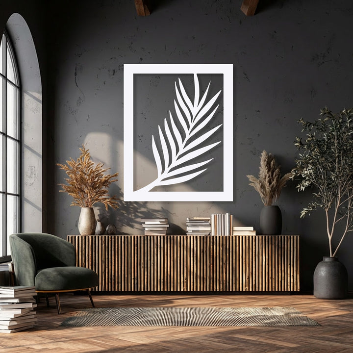 The crisp white finish of this modern botanical metal artwork elegantly highlights the minimal palm leaf silhouette.
