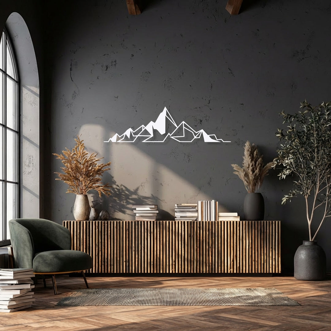 A white geometric mountain metal decoration wall art piece adds layered depth against a dark wall, positioned above a rich wooden console table.