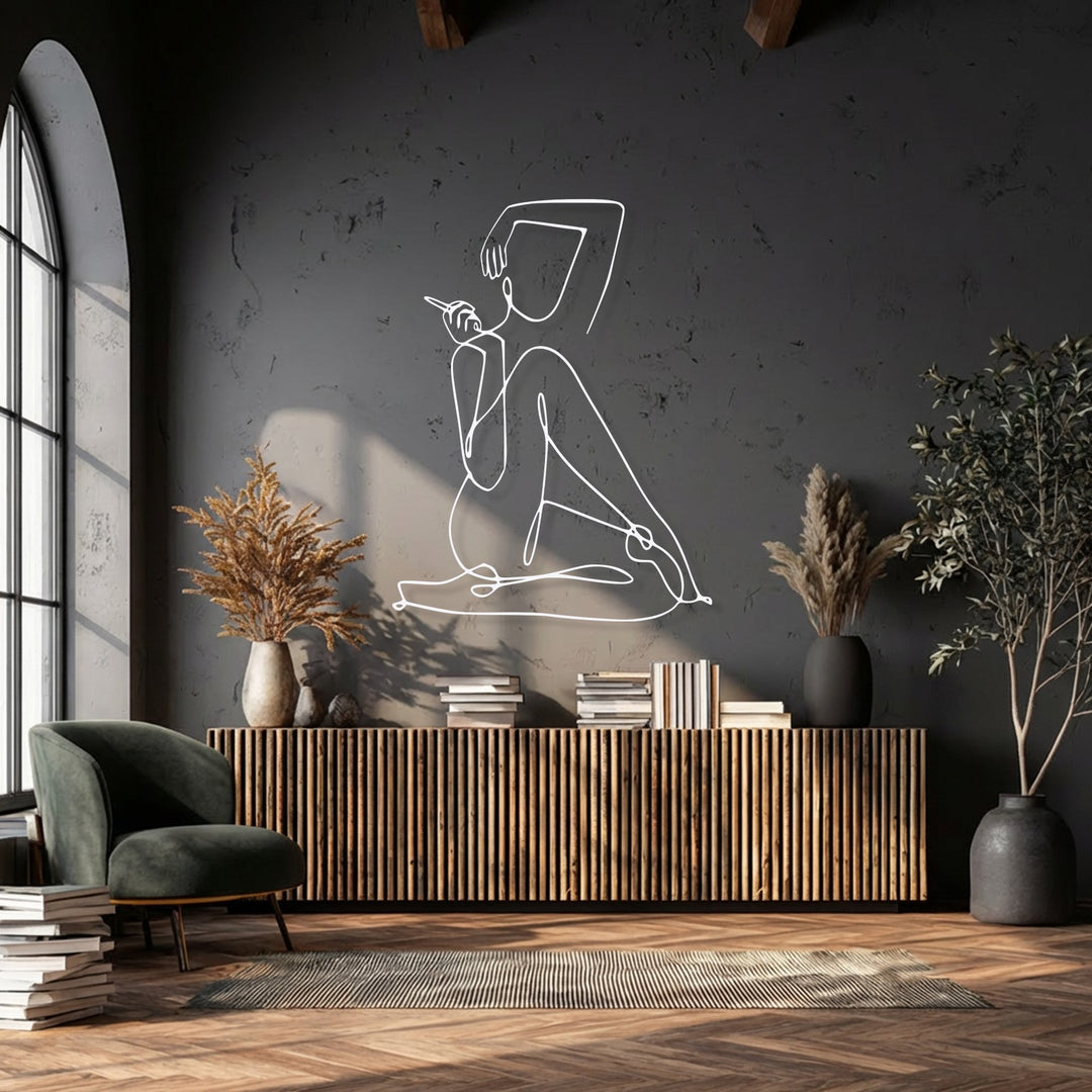 The cool color temperature of the dark wall provides a striking backdrop for unique metal wall art of an elegant abstract female figure.