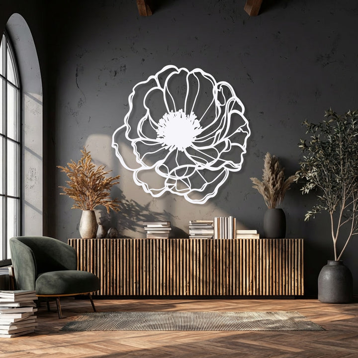 A striking color contrast is achieved with the luminous white elegant bloom outline metal art for wall against a dark charcoal textured wall.