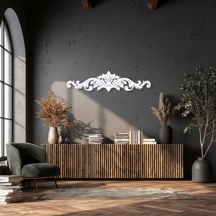 The stark color contrast highlights the elegant white ornamental scroll decorative metal art against the deep charcoal wall.