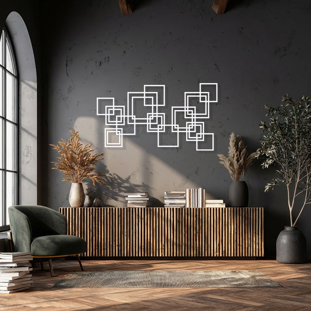 Velvety textures of the armchair and feathery dried arrangements beautifully soften the space, adorned with unique metal wall art.