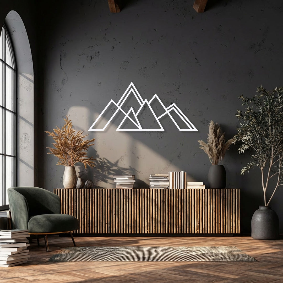 The inviting color temperature of this room, with warm sunlight illuminating the geometric mountain metal artwork, creates a cozy modern aesthetic.