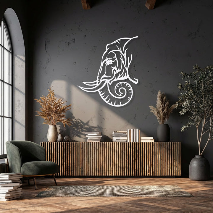 A majestic, intricate white elephant tribal-inspired metal art for wall prominently displayed against a dark textured wall.
