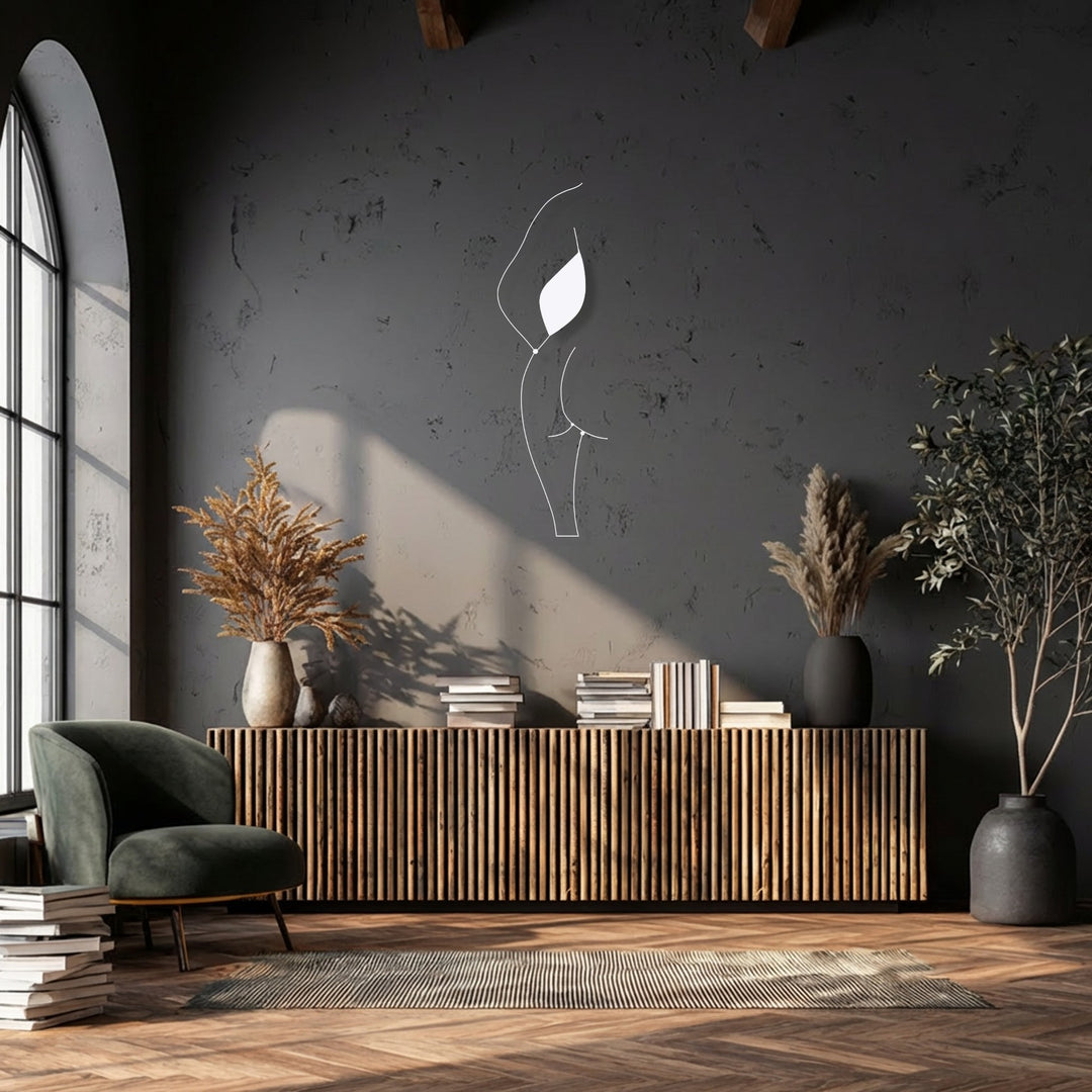 Geometric outlines of a unique metal wall art piece, depicting a minimalist female silhouette, contrast with the room's slatted cabinet.