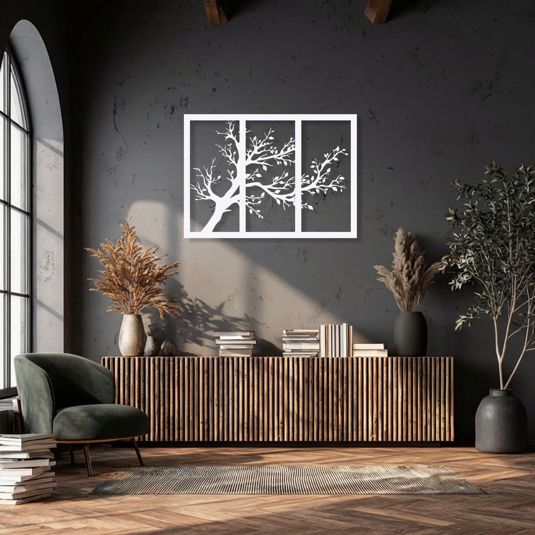 The sleek white borders of the minimalist tree silhouette triptych stand out against the dark wall, showcasing modern metal wall decor.