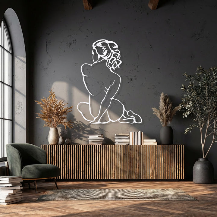 A dynamic minimal female figure metal artwork captures the elegant, poised movement of a body in silent grace.